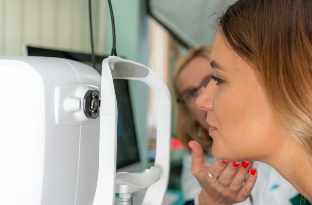 An optometrist conducting an eye exam for a female patient.